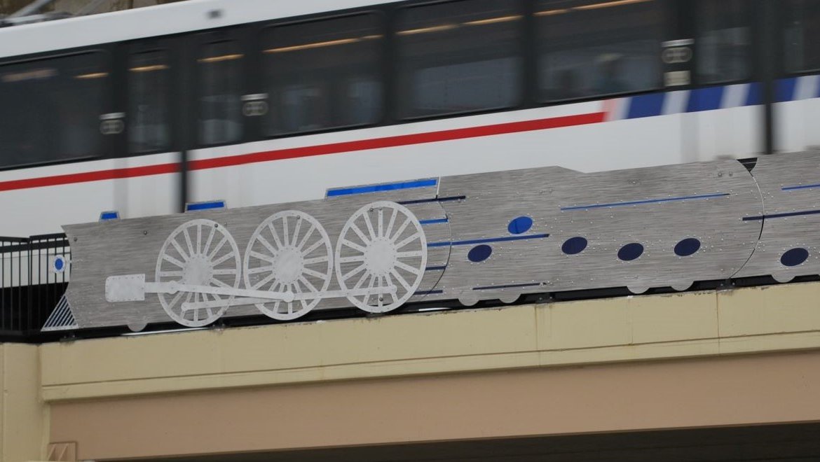 Blue Train is a public art sculpture by artist Clark Wiegman that is installed on the Vandeventer Avenue MetroLink Bridge. The piece is an abstracted train and locomotive with the opening 8 bars of "St. Louis Blues" depicted as a series of blue notes.