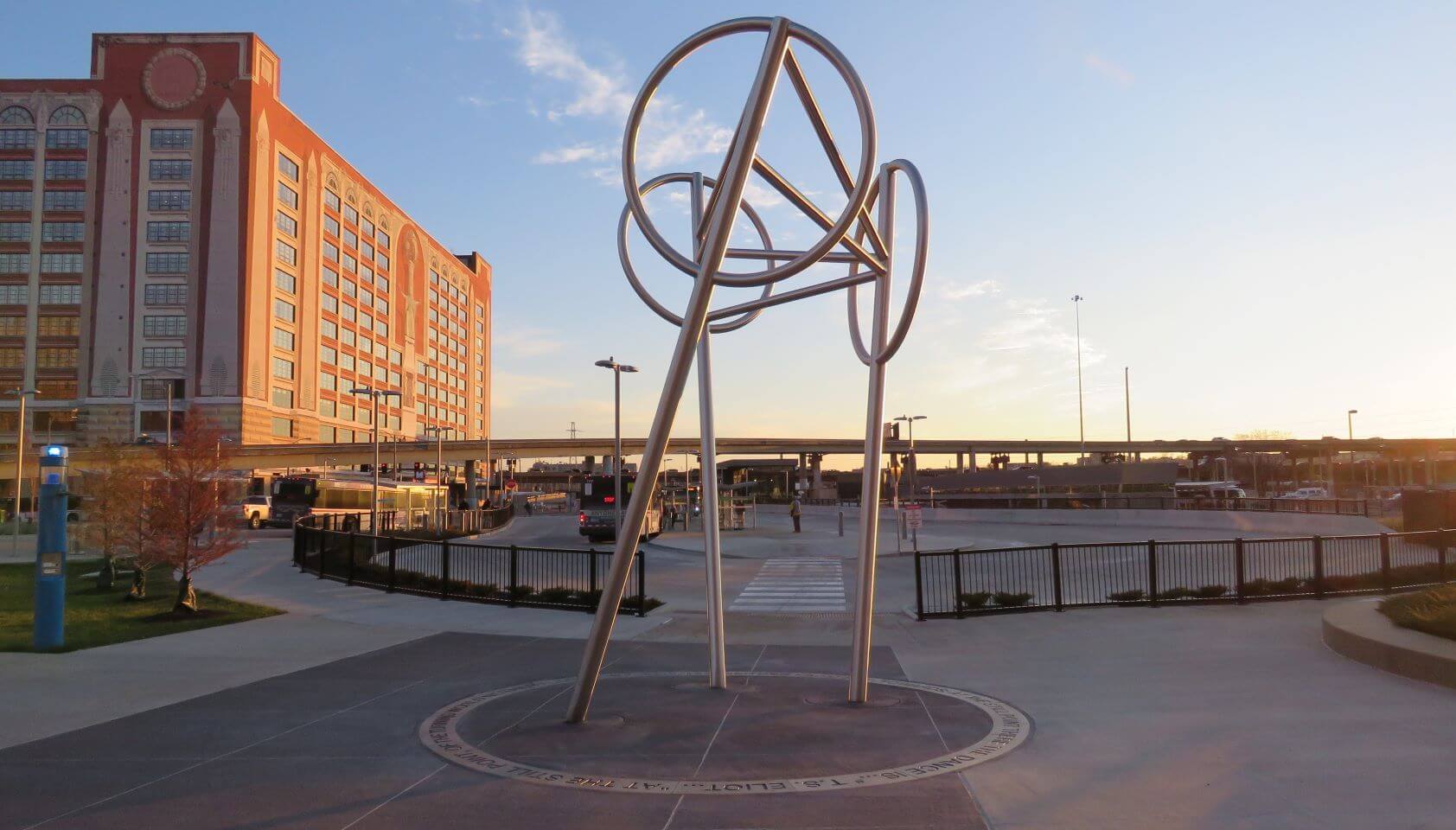 Wheels is a public art sculpture by artists Bill Baker and Claudia Cuesta located at the Civic Center Transit Center. The sculpture is a symbol of the movement and life of people, trains, buses, and the city. The sculpture is ringed with a poem by T.S. Eliot.