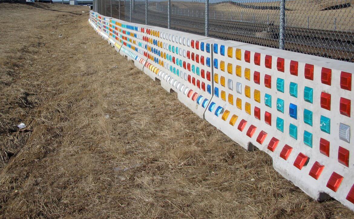 St. Louis Rhythm is light-activated public artwork by artist Richard Elliot located along the MetroLink Right of Way near Interstate 70. The patterned artowk is composed of road reflectors attached to concrete Jersey barriers.