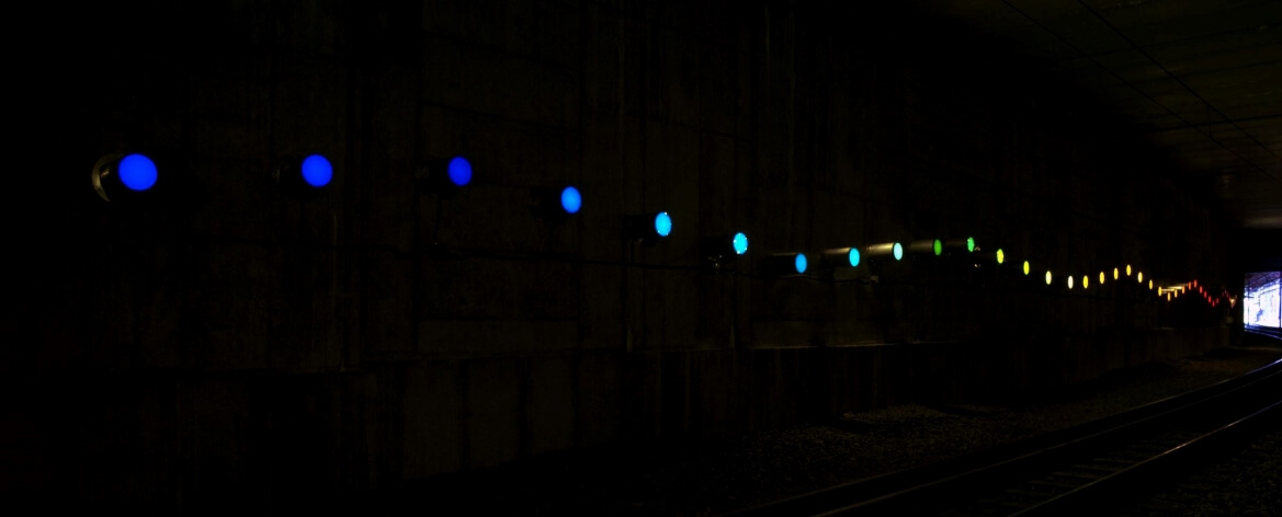 Ohne Titel is installed in the Central West End MetroLink tunnel and was created by artist Olafur Eliasson. The 60-lamp spectral light sculpture heightens the experience of movement and introduces dynamic sensations of color and light.